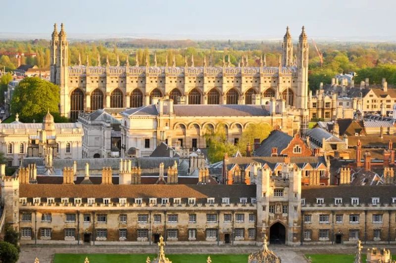 Aerial view of King's College Chapel and surrounding Cambridge colleges in golden light.